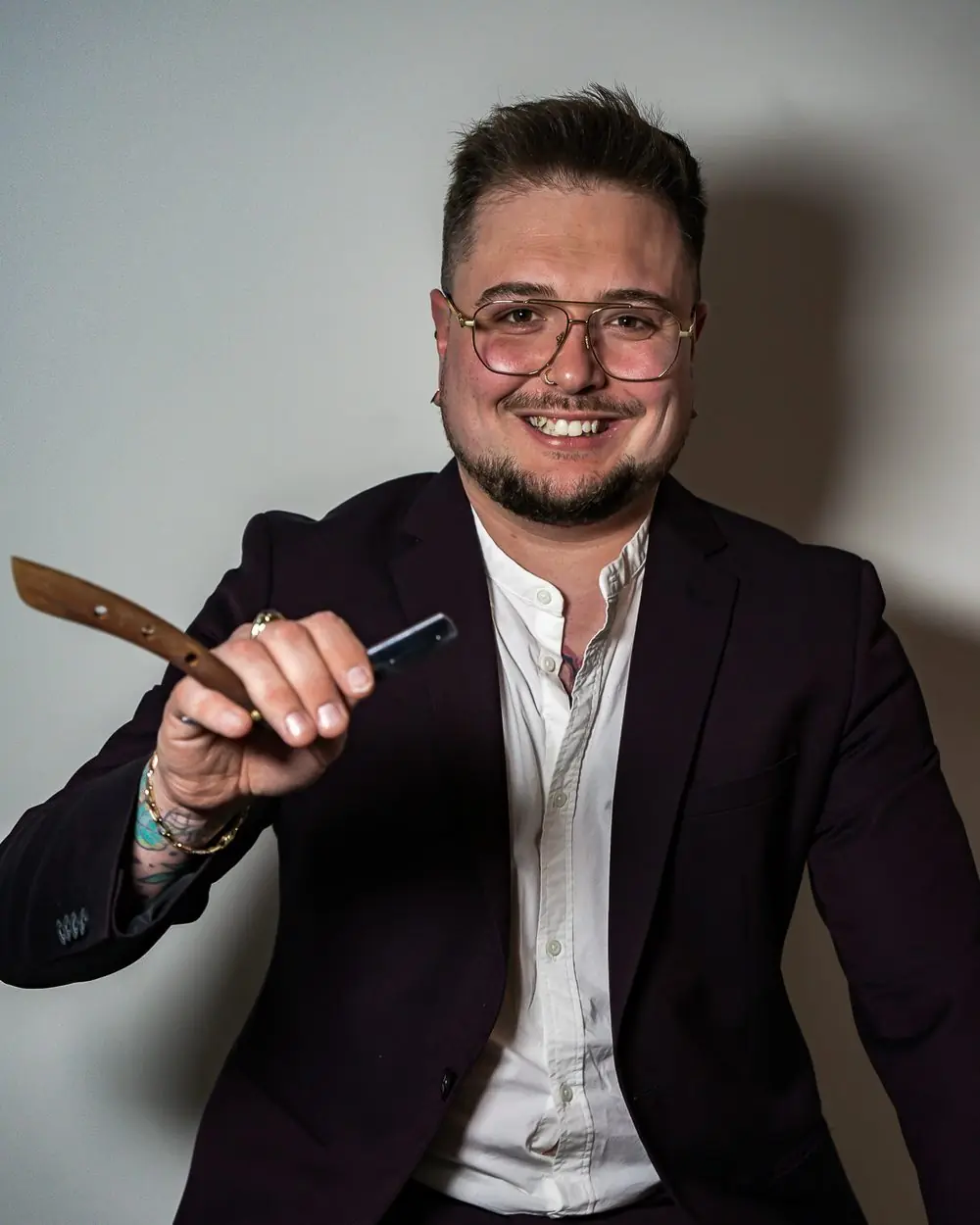 Joey Ouellet, owner of Le Barbier Privé in Sherbrooke, holding a straight razor